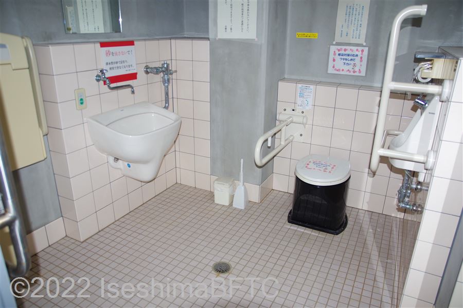 国府白浜園地休憩舎トイレ側内部　入口からみて正面に、たて置きに便器。手洗いは便器横